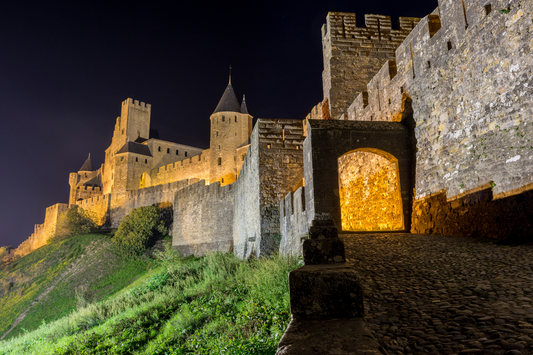 Stroll Walk by night in the medieval cite of Carcassonne Citadel in Occitanie France Aude South of France lights lices Exterior Ramparts Castle